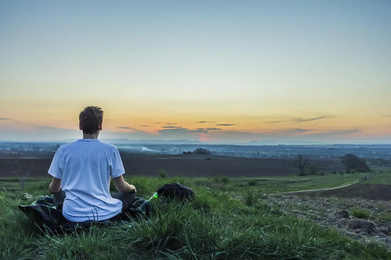 Stock photo: stressed person trying to meditate indoors