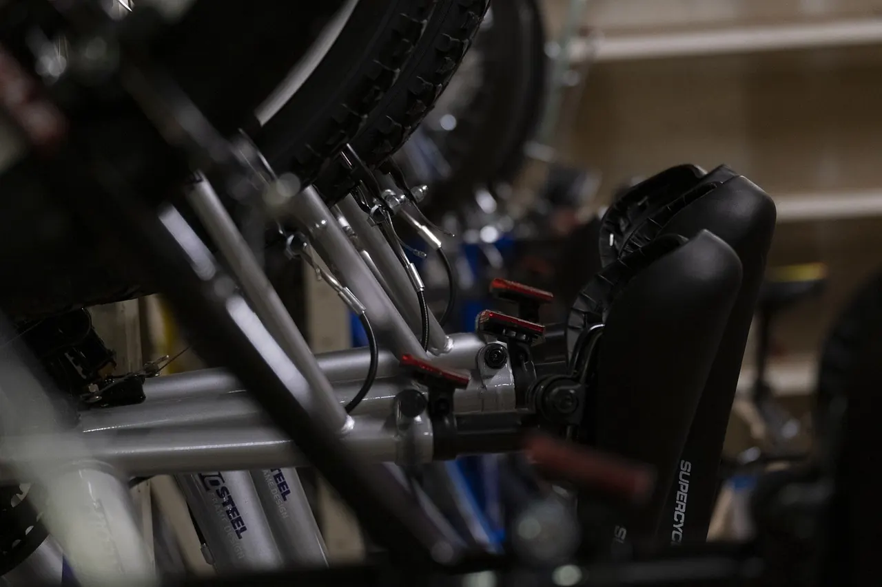 Stock photo: bicycle mechanic working outside bike shop