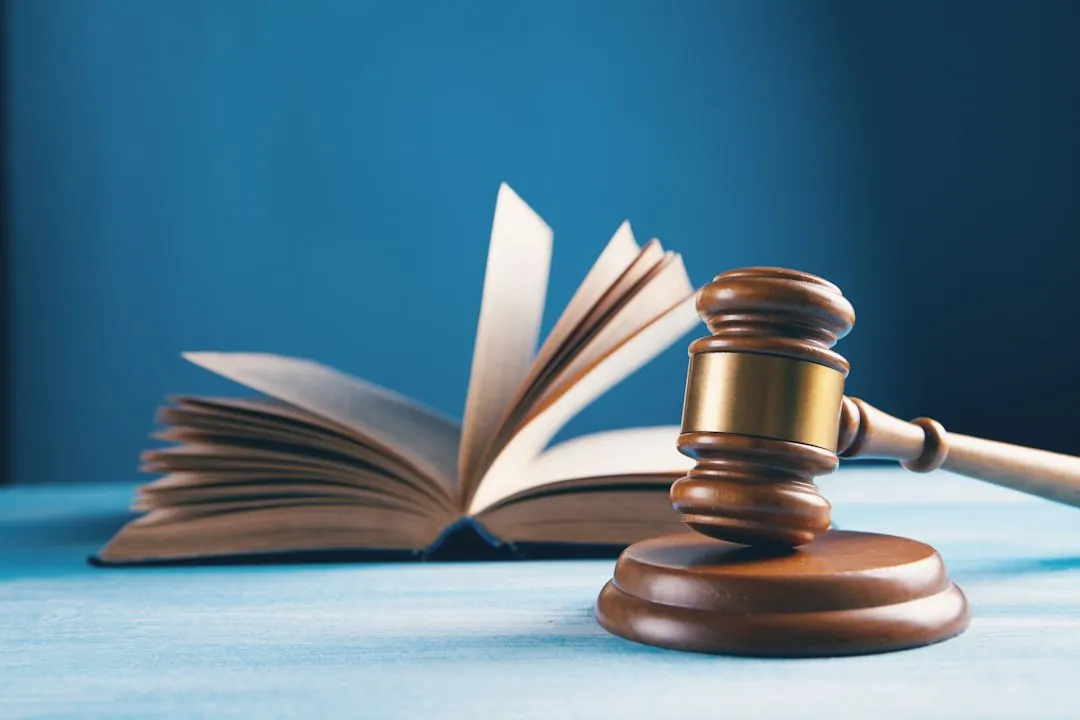 Stock photo: open law book with wooden judge gavel