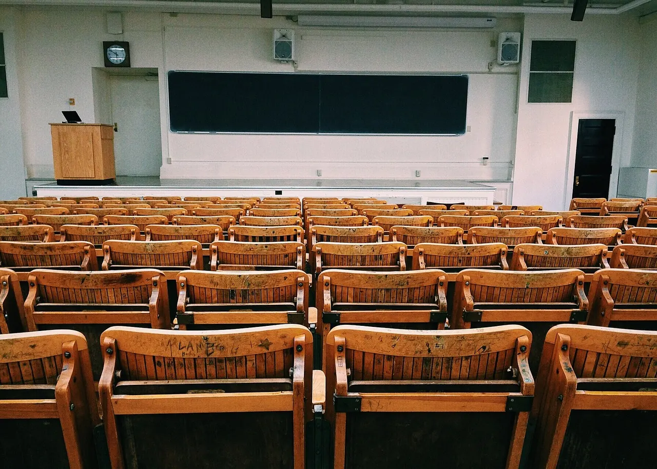 Foto de archivo: aula universitaria vacía con pupitres