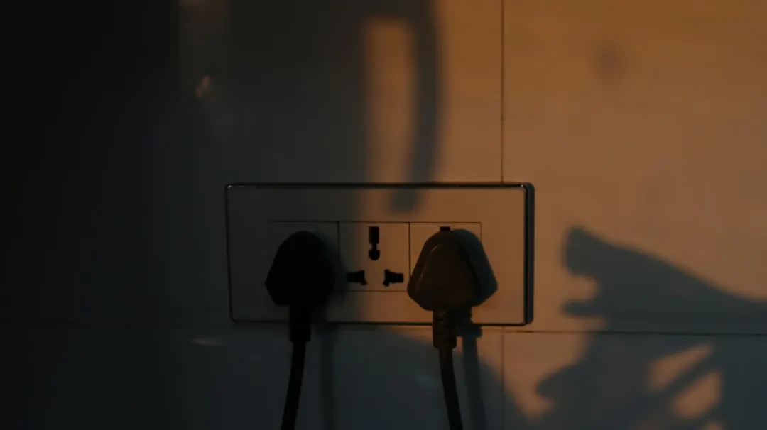 Stock photo: an overloaded wall socket with multiple plugs