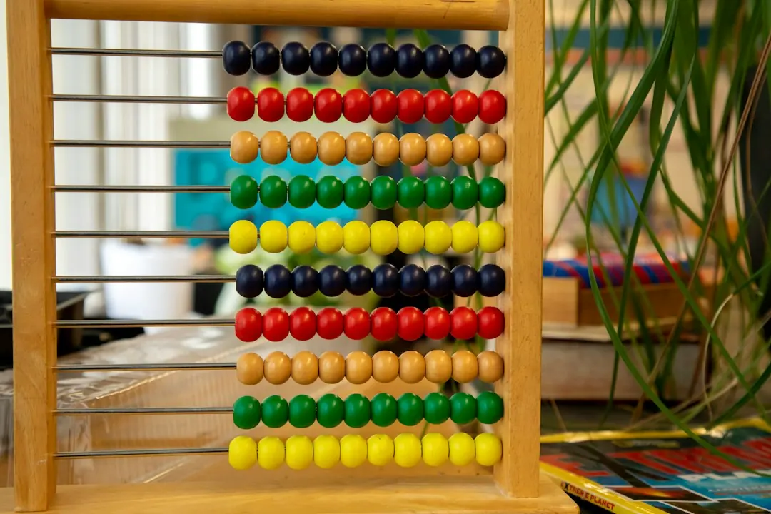 Stock photo: a wooden abacus on an office desk