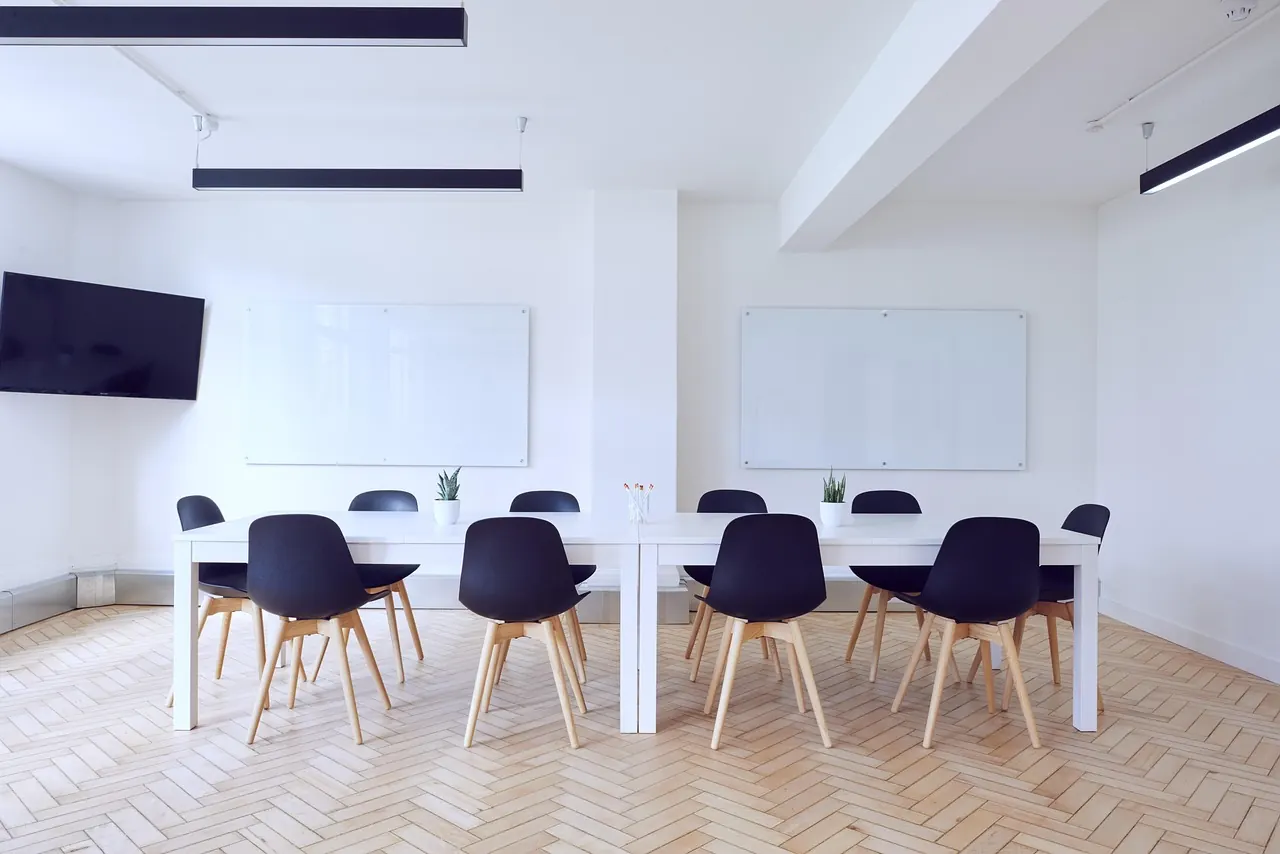 Stock photo: businessman sitting alone in empty boardroom