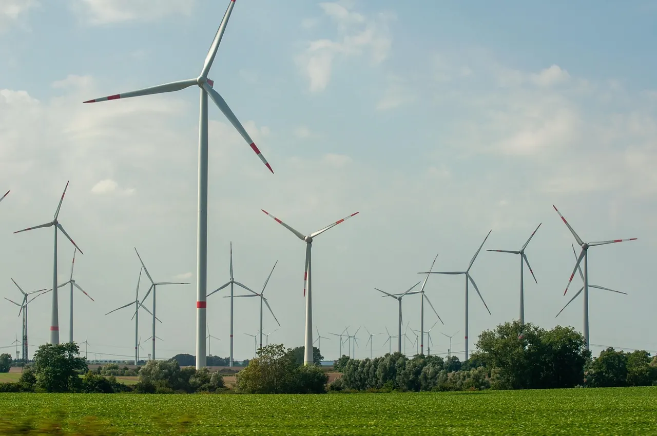 Stock photo: Wind turbine standing near smoking power plant