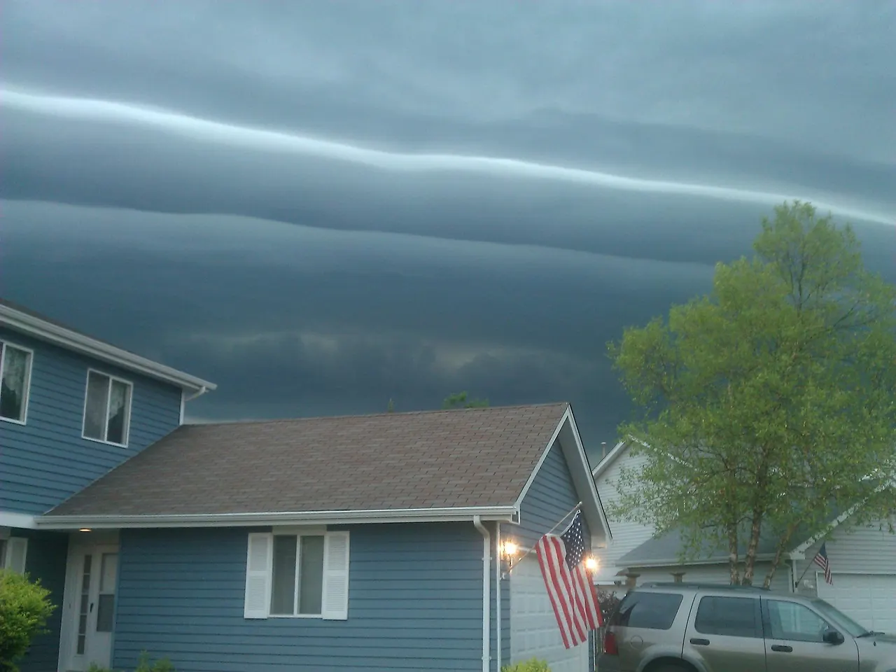 Stock photo: rain clouds gathering over suburban neighborhood houses