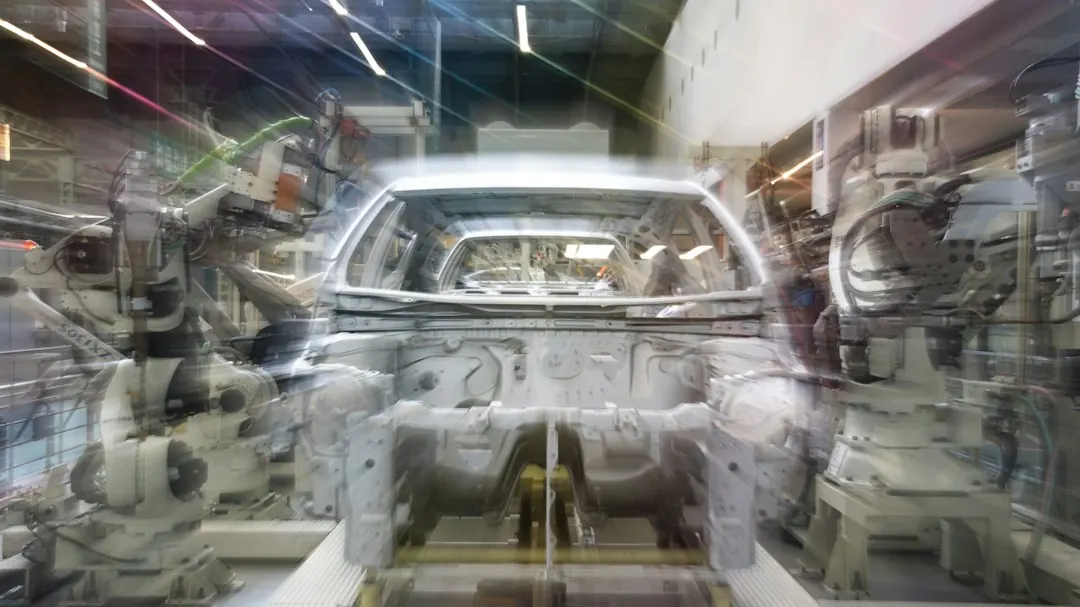Stock photo: robotic arms assembling a car in factory