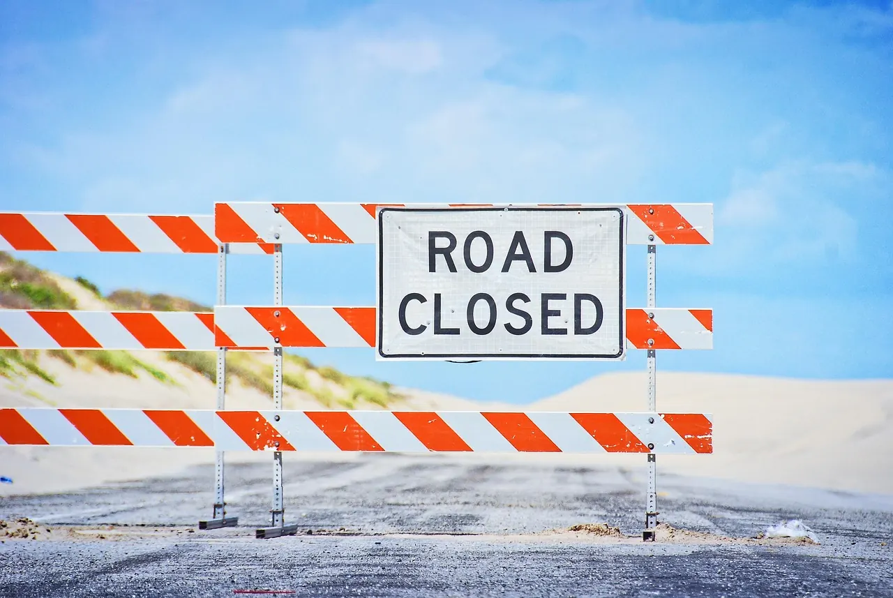 Stock photo: caution tape on a closed sandy beach