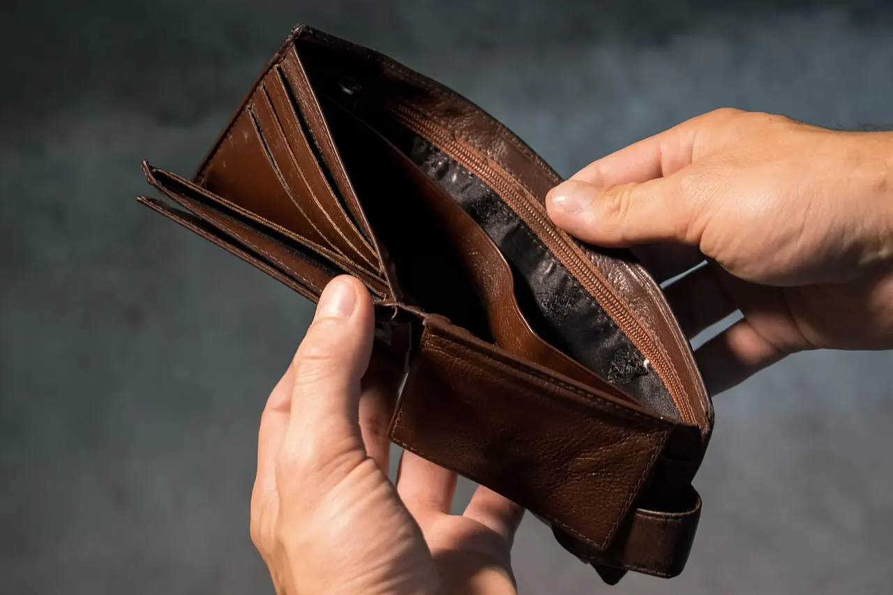 Stock photo: person holding empty wallet while shopping