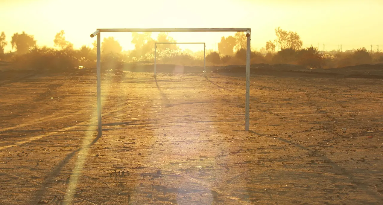 Stock photo: empty football goalposts on grass pitch