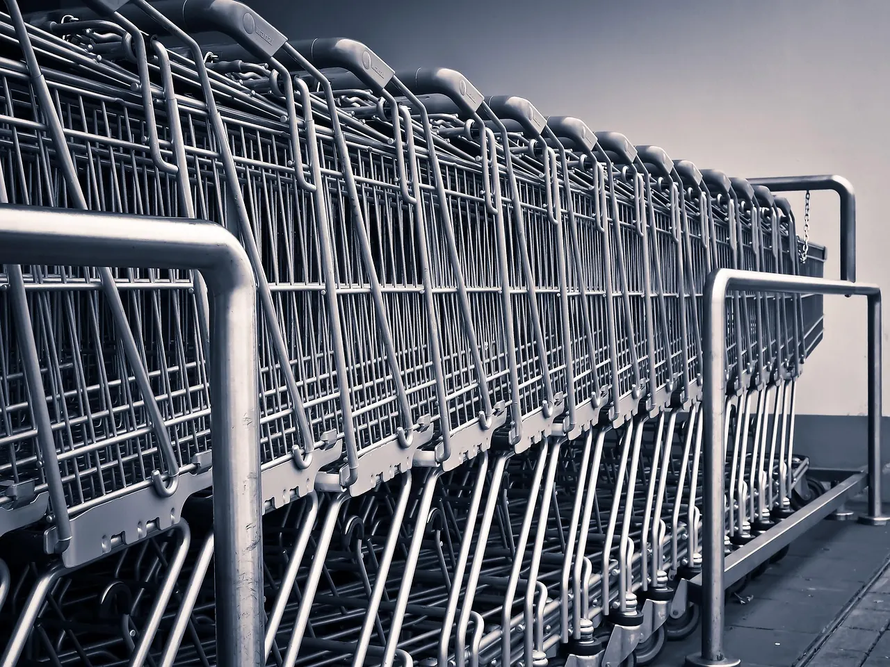 Stock photo: An empty shopping cart in a supermarket aisle